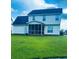 Spacious backyard featuring a screened-in porch, a grassy yard, and a two-story home at 620 Saint Ives Ln, Goose Creek, SC 29445