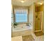 Relaxing bathroom featuring a soaking tub, shower, and natural light from a window at 620 Saint Ives Ln, Goose Creek, SC 29445