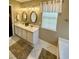 Bright bathroom featuring dual sinks, vanity, and stylish mirrors with modern lighting at 620 Saint Ives Ln, Goose Creek, SC 29445
