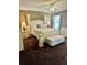 Elegantly furnished bedroom showcasing a four-poster bed, bench, and neutral decor at 620 Saint Ives Ln, Goose Creek, SC 29445