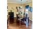 Elegant dining room featuring a dark wood table, decorative art, and sophisticated lighting at 620 Saint Ives Ln, Goose Creek, SC 29445