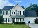 Charming two-story home with a well-manicured lawn and black shutters, offering classic curb appeal at 620 Saint Ives Ln, Goose Creek, SC 29445
