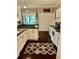 Well-lit kitchen with white cabinets, dark countertops, modern appliances, and a stylish rug at 620 Saint Ives Ln, Goose Creek, SC 29445