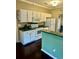Bright kitchen featuring white cabinets, stainless steel appliances, a breakfast bar, and hardwood floors at 620 Saint Ives Ln, Goose Creek, SC 29445