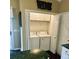 Convenient laundry area with washer, dryer, and storage cabinets, discreetly tucked away in the kitchen at 620 Saint Ives Ln, Goose Creek, SC 29445