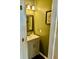 Cozy powder room featuring a modern vanity, decorative mirror, and neutral tones at 620 Saint Ives Ln, Goose Creek, SC 29445