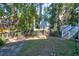 Landscaped backyard with grassy area, trees, plants, and a stepped deck at 794 Hunt Club Run, Charleston, SC 29414