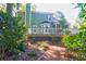 Landscaped backyard with trees, plants, and a stepped deck at 794 Hunt Club Run, Charleston, SC 29414