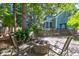 Backyard patio with brick fire pit surrounded by lush landscaping and mature trees at 794 Hunt Club Run, Charleston, SC 29414