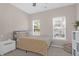 Well-lit bedroom features a neutral color palette, a ceiling fan, and windows offering natural light at 794 Hunt Club Run, Charleston, SC 29414
