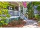 Charming front porch with hanging flower baskets, stairs, and an American flag at 794 Hunt Club Run, Charleston, SC 29414