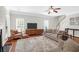 Bright living room offers a fireplace, hardwood floors and many windows at 794 Hunt Club Run, Charleston, SC 29414