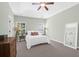Airy main bedroom showcasing a tray ceiling, neutral walls, and carpet floors creating a serene ambiance at 794 Hunt Club Run, Charleston, SC 29414