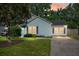 Charming single-story home featuring a well-manicured lawn and inviting curb appeal at dusk at 8108 Halifax Way, North Charleston, SC 29420