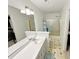 Bathroom with a large mirror, white cabinets, and a combined shower and tub at 8496 Roanoke Dr, North Charleston, SC 29406