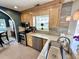 Well-appointed kitchen features granite countertops, stainless steel appliances, and ample natural light from the window at 8496 Roanoke Dr, North Charleston, SC 29406