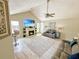 Bright living room features a cozy fireplace, vaulted ceilings, ceiling fan, and wood-look floors for a modern touch at 8496 Roanoke Dr, North Charleston, SC 29406