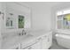 Bright bathroom features a marble countertop, soaking tub, and white cabinets at 9017 Stern Aly, Johns Island, SC 29455