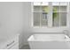 Bright bathroom featuring a soaking tub beneath a window at 9017 Stern Aly, Johns Island, SC 29455