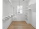 Bright walk-in closet with wooden floors, window, and shelving units at 9017 Stern Aly, Johns Island, SC 29455