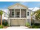 Attractive two-story white home with screened-in porch, garage, and landscaped yard at 9017 Stern Aly, Johns Island, SC 29455