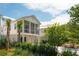 Two-story white home with screened porch, garage, and beautiful landscaping at 9017 Stern Aly, Johns Island, SC 29455