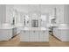 An open-concept kitchen featuring a central island with quartz countertops and stainless steel appliances at 9017 Stern Aly, Johns Island, SC 29455