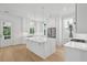 Quartz counter tops and a stainless refrigerator are highlights of this kitchen with natural light at 9017 Stern Aly, Johns Island, SC 29455