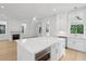 Kitchen island with stainless oven, quartz countertop and view into the main living area at 9017 Stern Aly, Johns Island, SC 29455