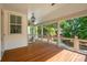 Spacious porch with wood floors, white railings, and views of the surrounding greenery at 9017 Stern Aly, Johns Island, SC 29455