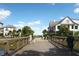 Charming street view of beautifully designed homes with lush landscaping, blue skies and families out walking, biking and socializing at 9017 Stern Aly, Johns Island, SC 29455