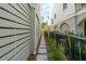 Narrow walkway between homes with stone path, landscaping, and privacy fencing at 9017 Stern Aly, Johns Island, SC 29455