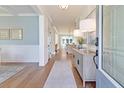 Bright entryway with hardwood floors, a console table, and view to the kitchen at 173 Fiddleback Dr, Summerville, SC 29486