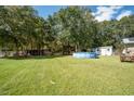 Large backyard with above ground pool, shed, and picnic table at 175 Maria Stuart Ln, Varnville, SC 29944