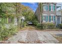 Brick driveway between two houses with lush greenery at 190 Coming St, Charleston, SC 29403