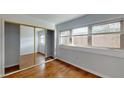 Bright bedroom with mirrored closet doors and wood flooring at 40 Bee St # 111, Charleston, SC 29403