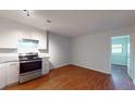 Eat-in kitchen featuring stainless steel appliances and wood flooring at 40 Bee St # 111, Charleston, SC 29403