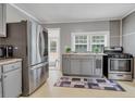 Stainless steel appliances and gray cabinets in this galley kitchen at 8375 Shell House Rd, Edisto Island, SC 29438