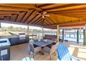 Covered outdoor kitchen and dining area with water views at 633 Barbados Dr, Charleston, SC 29492