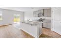 Modern kitchen with gray cabinets, granite countertops, and island at 132 Morning View Way, Moncks Corner, SC 29461