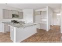 Modern kitchen with gray cabinets, granite countertops, and island at 132 Morning View Way, Moncks Corner, SC 29461