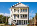 Two-story home with front porch, balconies, and double garage doors at 1636 Siloh St # 478, Mount Pleasant, SC 29466