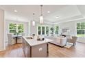 Modern kitchen with gray cabinets, island, and stainless steel appliances at 418 Queenview Ln, Charleston, SC 29414