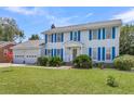 Two-story house with blue shutters, attached garage, and green lawn at 13 Charlyn Dr, Charleston, SC 29407