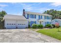 Two-story house with blue shutters, attached garage, and landscaped yard at 13 Charlyn Dr, Charleston, SC 29407