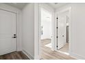 Inviting hallway features clean lines, light wood floors, and access to a bedroom and bathroom at 133 Summerwind Dr, Summerville, SC 29486