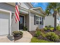 Inviting front entrance with a black door, American flag, and landscaping at 360 Bering Ln, Summerville, SC 29486