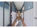 Entryway view with stylish rug, blue walls, and white wainscoting at 360 Bering Ln, Summerville, SC 29486