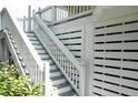 White wooden stairs leading down from a deck at 2 Pelican Reach # Share 10, Isle of Palms, SC 29451