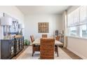 Bright dining room featuring a light-colored table, woven chairs, and large windows at 285 Blue Haw Dr, Moncks Corner, SC 29461